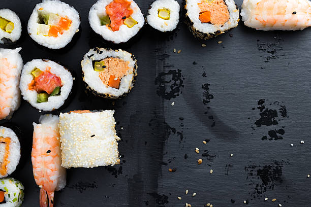 istock Japanese sushi on black kitchen slate plate. 628992928
