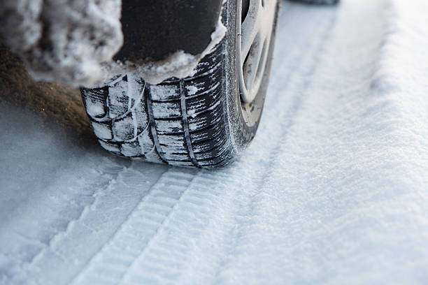 istock Car tires on winter road 628992932