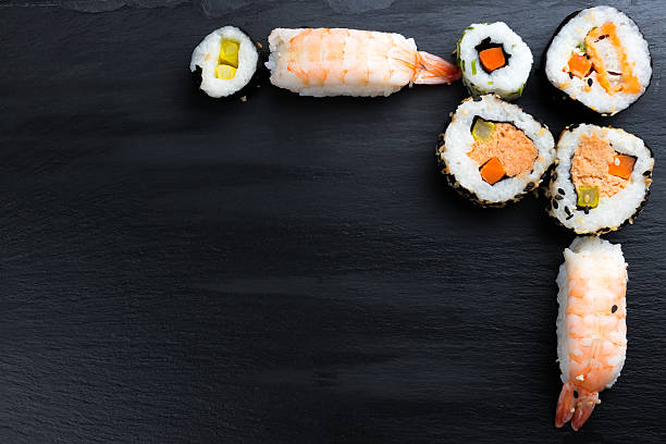 istock Japanese sushi on black kitchen slate plate. 628993018