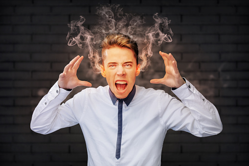 Angry man screaming with smoke coming out of his ears