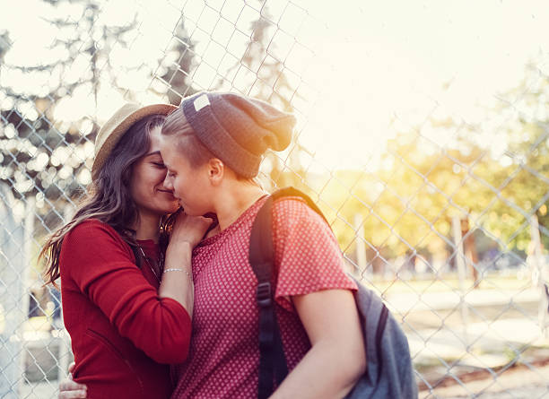 Lesbian couple in love Homosexual couple kissing in the city park teen romance stock pictures, royalty-free photos & images