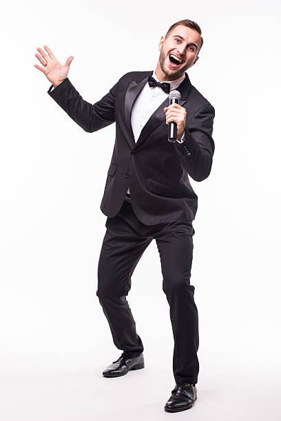 istock The Showman interviewer with emotions. Young elegant man holding microphone 628997550