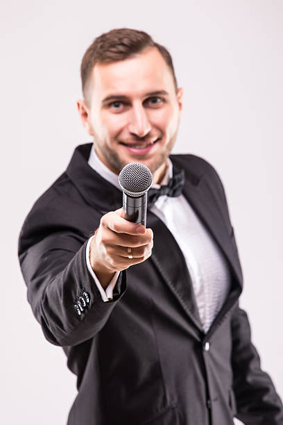 istock The Showman interviewer. Young elegant man holding microphone 628997748