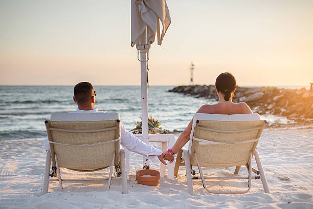 istock Couple relaxing at sunbead enjoying beautiful sunset 629006472