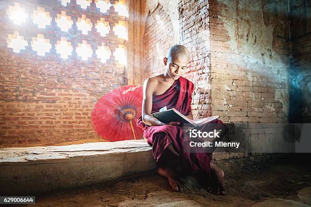 Burmese Novice Buddhist Monk In Temple Reading Bagan Myanmar Stock Photo - Download Image Now