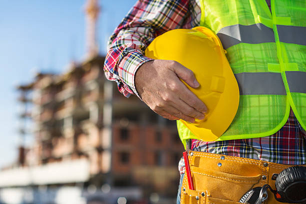 istock Worker holding hard hat close up shot 629007488