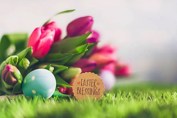 Photo of Easter arrangement with fresh tulips, Easter eggs and Easter message