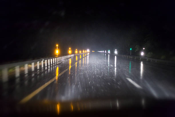 istock Night Warning Light Lens Flare Reflections Through Speeding Car Windshield 629009114