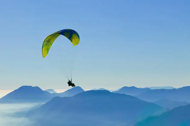 Freedom concept of two people flying above the mountains