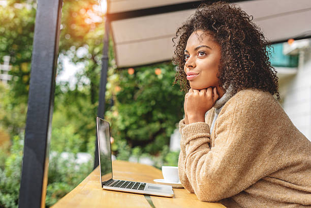istock student sitting in front of laptop outdoors 629010228