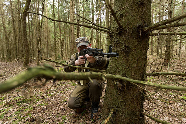 istock soldiers in the coniferous forest with a gun 629010430