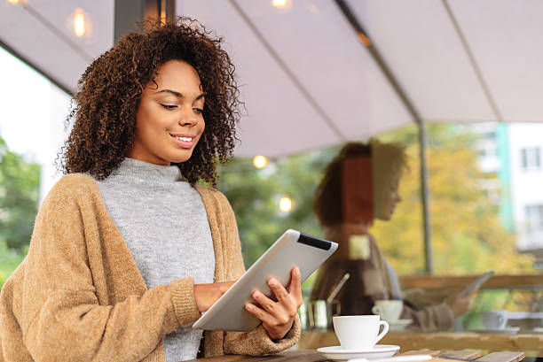 istock cheerful girl using tablet outdoors 629010722