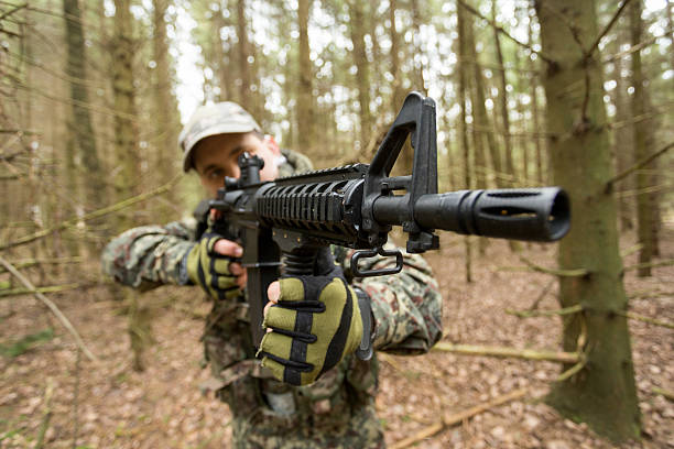 istock soldiers in the coniferous forest with a gun 629011008