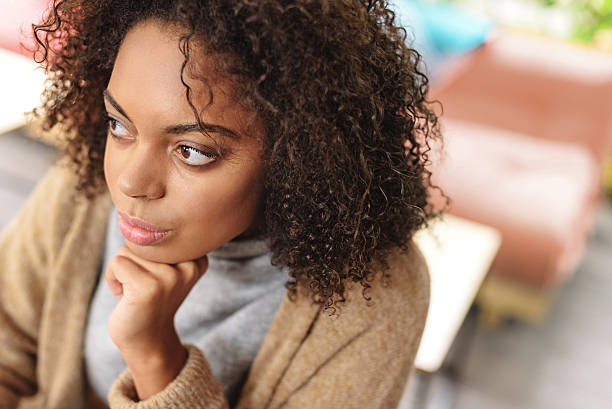istock lady with curly hair thinking 629011166