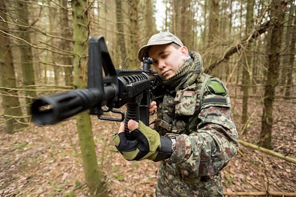 istock soldiers in the coniferous forest with a gun 629011170