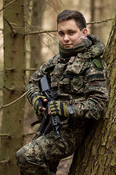 istock soldiers in the coniferous forest with a gun 629011374