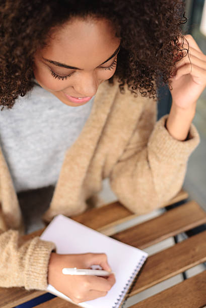 istock cute woman taking notes indoors 629011392