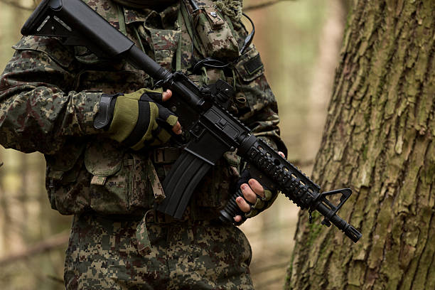 istock soldiers in the coniferous forest with a gun 629011484