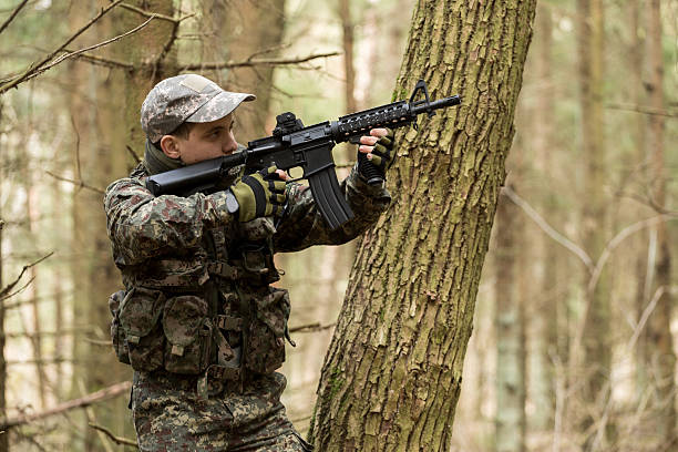 istock soldiers in the coniferous forest with a gun 629011560