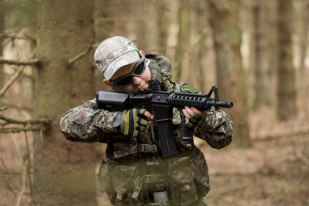 istock soldiers in the coniferous forest with a gun 629011858