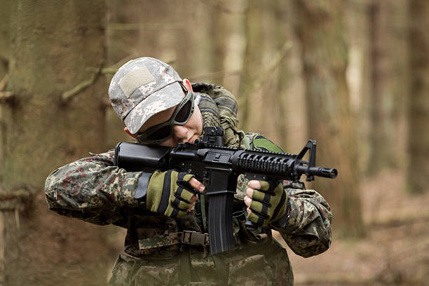 istock soldiers in the coniferous forest with a gun 629011868