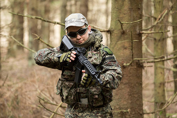 istock soldiers in the coniferous forest with a gun 629011908