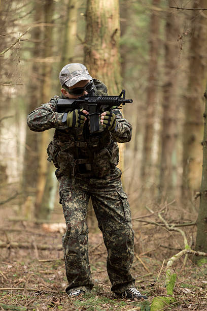 istock soldiers in the coniferous forest with a gun 629012056