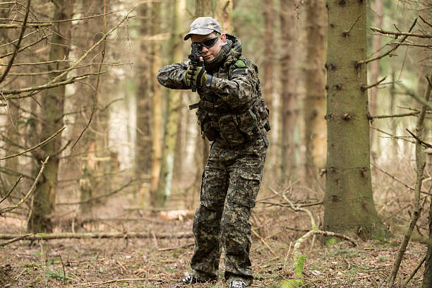 istock soldiers in the coniferous forest with a gun 629012176