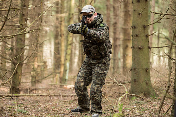 istock soldiers in the coniferous forest with a gun 629012188