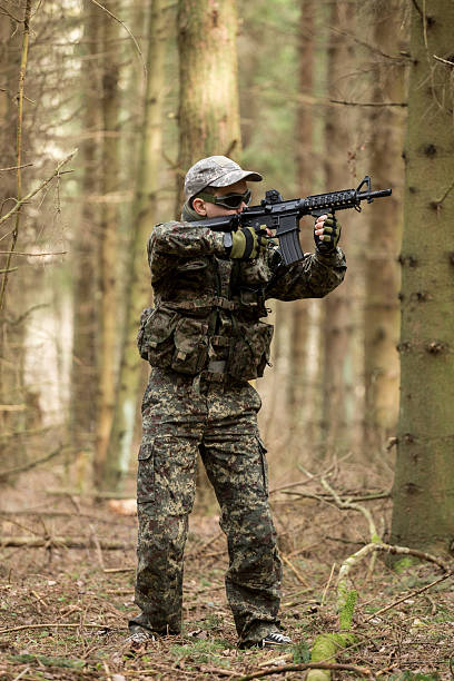 istock soldiers in the coniferous forest with a gun 629012214