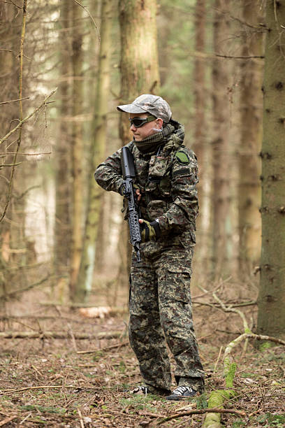 istock soldiers in the coniferous forest with a gun 629012236