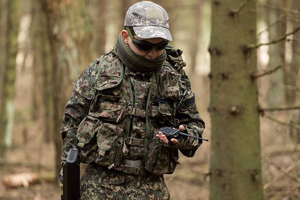 istock soldiers in the coniferous forest with a gun 629012386