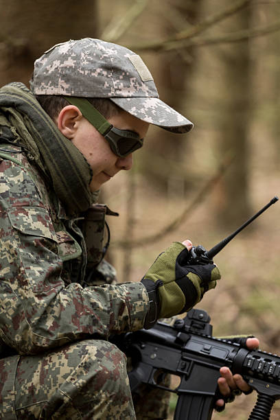 istock soldiers in the coniferous forest with a gun 629012624