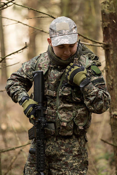 istock soldiers in the coniferous forest with a gun 629012784