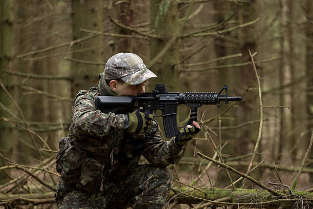 istock soldiers in the coniferous forest with a gun 629012828