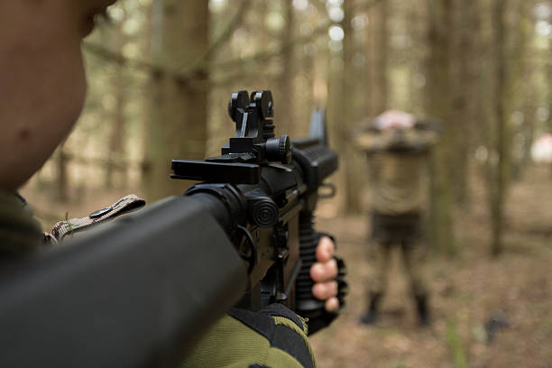 istock soldiers in the coniferous forest with a gun 629018934