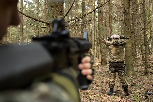 istock soldiers in the coniferous forest with a gun 629019022