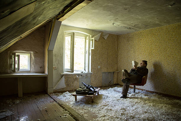 istock man with a gun in the Abandoned destroyed house 629019396