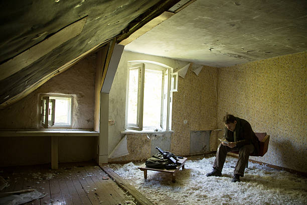 istock man with a gun in the Abandoned destroyed house 629019408