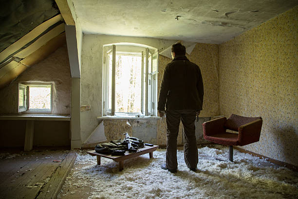istock man with a gun in the Abandoned destroyed house 629019562