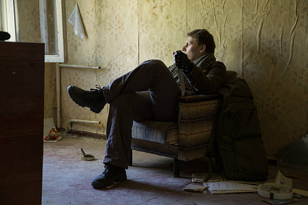 istock man with a gun in the Abandoned destroyed house 629019696