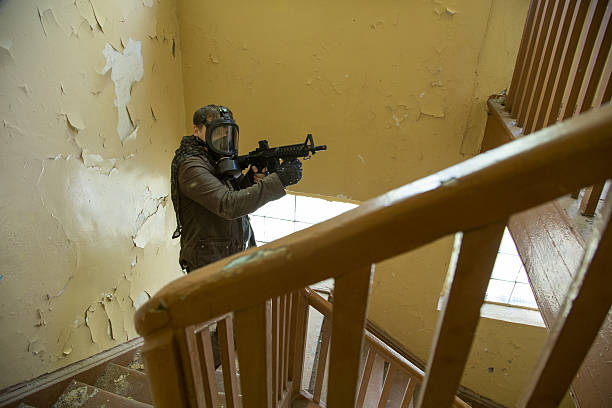 istock man with a gun in the Abandoned destroyed house 629020010
