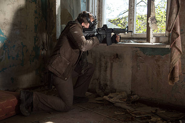 istock man with a gun in the Abandoned destroyed house 629020572