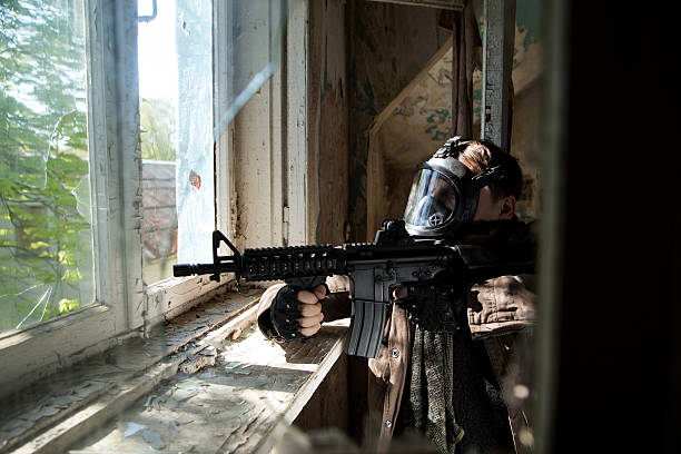 istock man with a gun in the Abandoned destroyed house 629020776