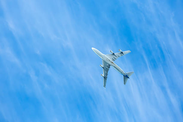 istock airplane on the blue sky, seen from below 629023844