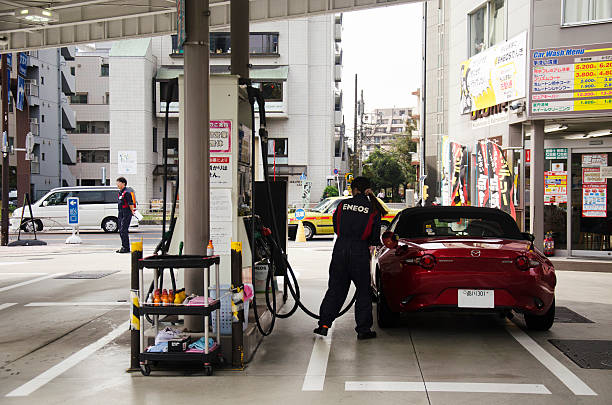 People drive car go to fill oil in petrol station stock photo