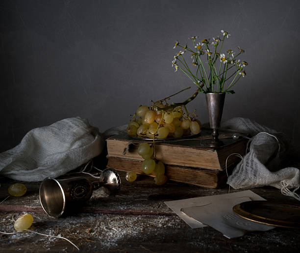 istock still life, vintage. silver platter with grapes, cake, drapery, a 629032958