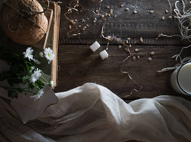 still life, vintage. old books, a glass of milk, cakes