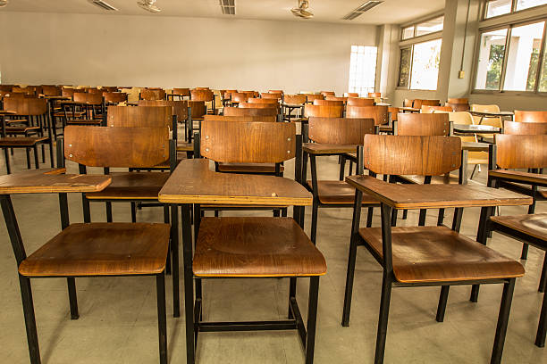 istock Old scattered chairs in the classroom. 629048756