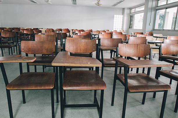 istock Old scattered chairs in the classroom. 629048828